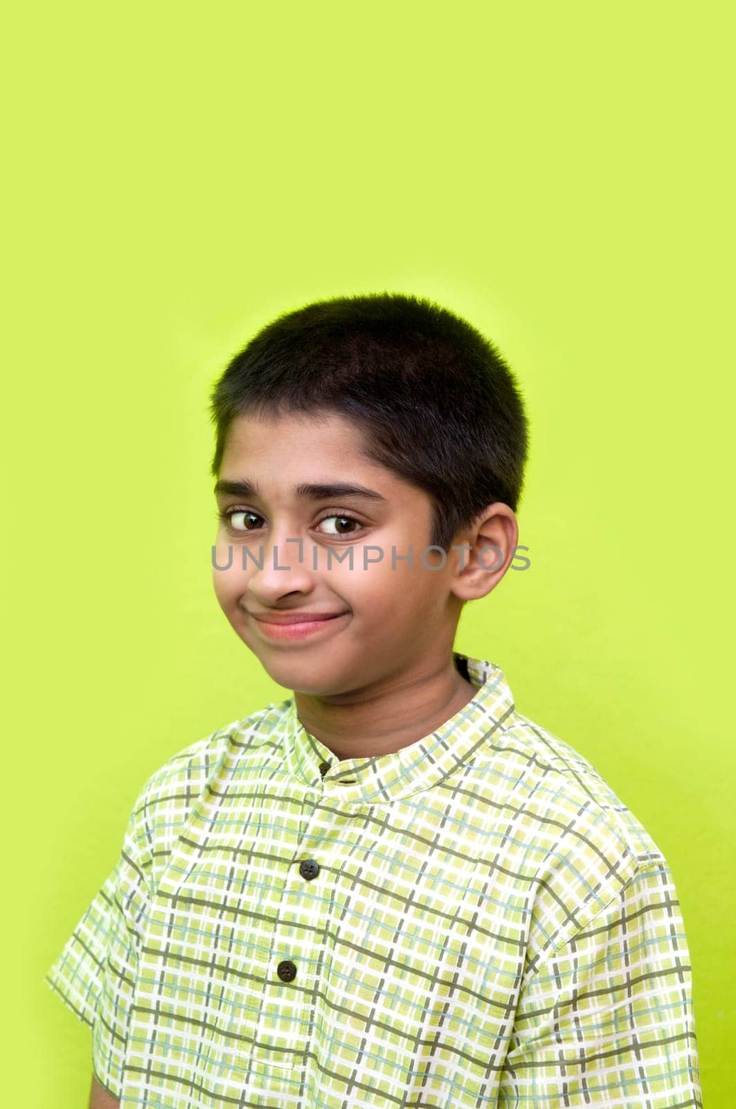 An handsome Indian kid smiling nicely for you