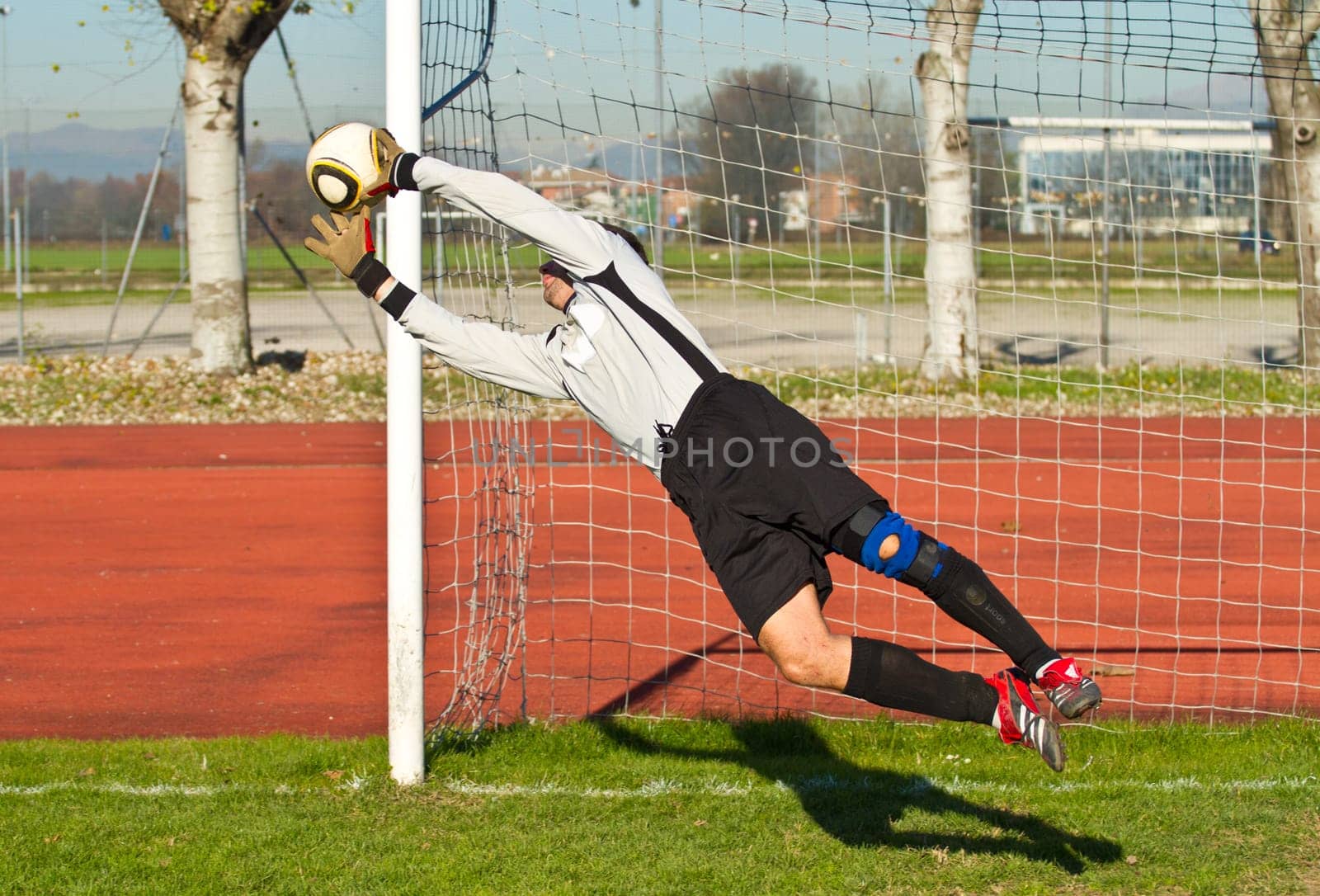 Soccer football goalkeeper making diving save