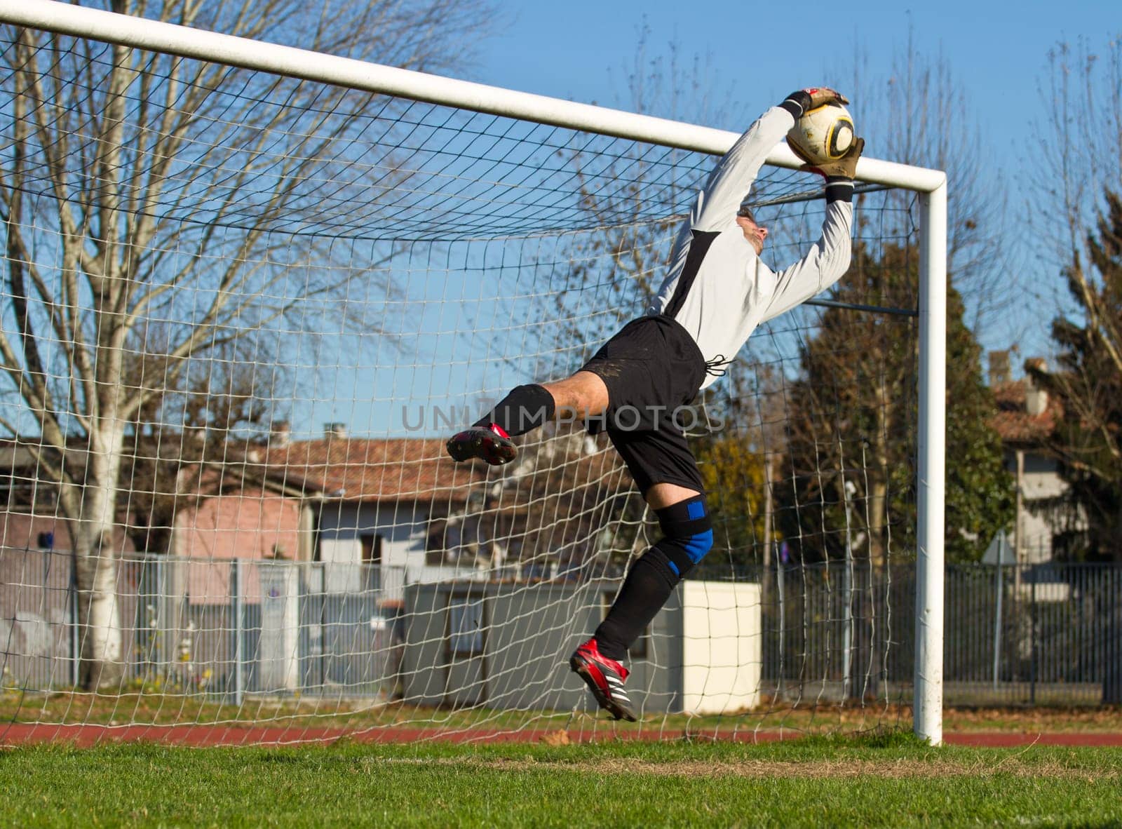 Soccer football goalkeeper making diving save