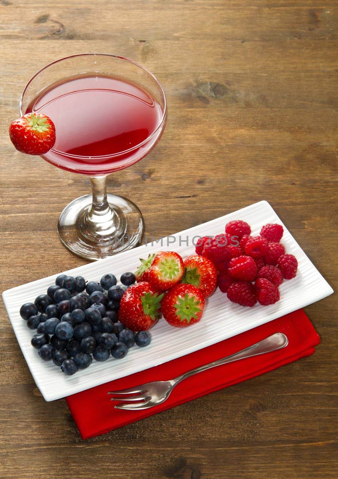 fruit juice with berries on wooden background