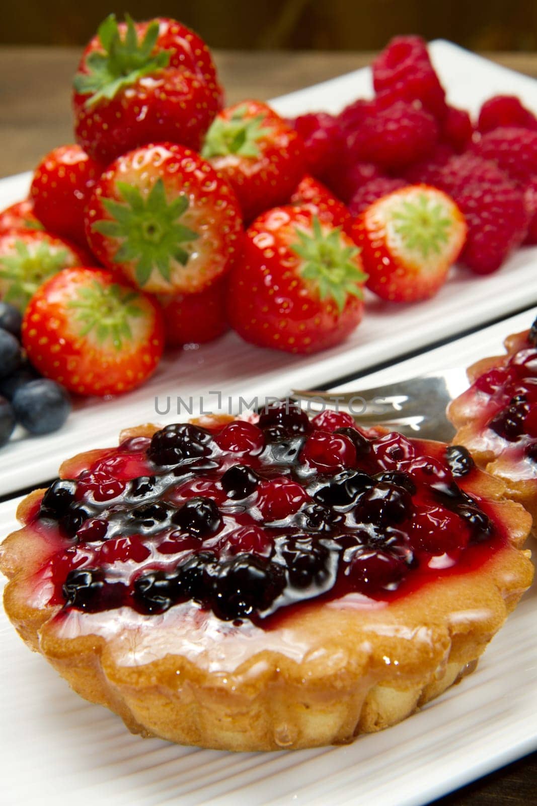 cake with berries on wooden background