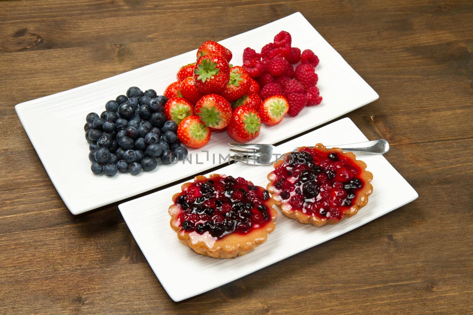 cake with berries on wooden background