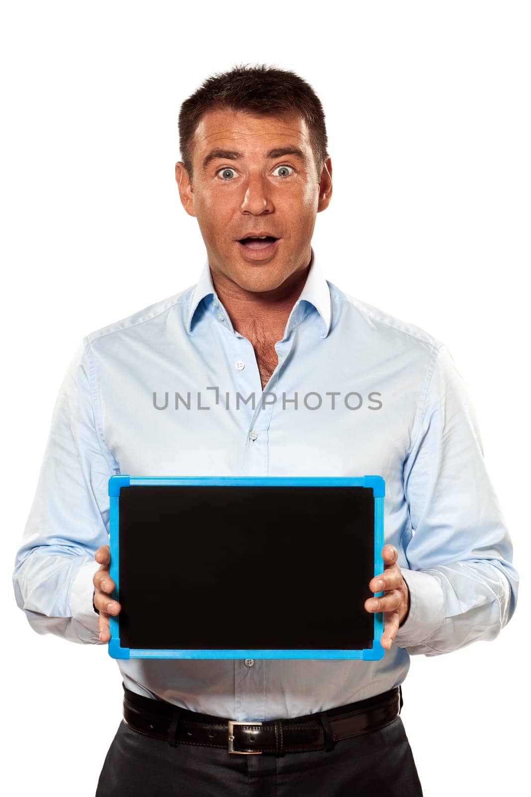 one surprised caucasian business man holding a blackboard copy space message in studio isolated on white background