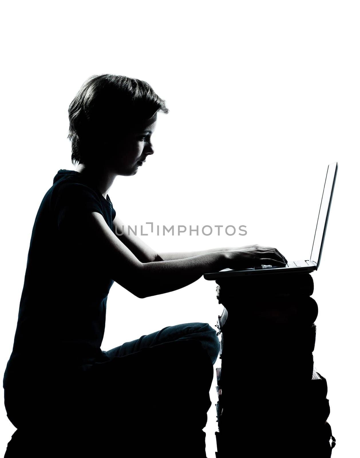 one caucasian young teenager silhouette boy or girl sitting computer computing laptop books full length in studio cut out isolated on white background