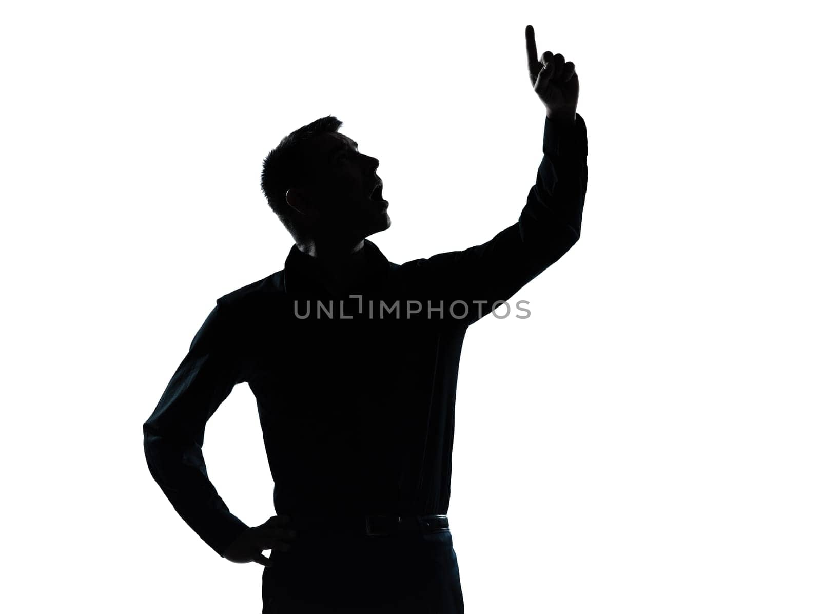 one caucasian business man pointing up surprised  portrait silhouette in studio isolated on white background
