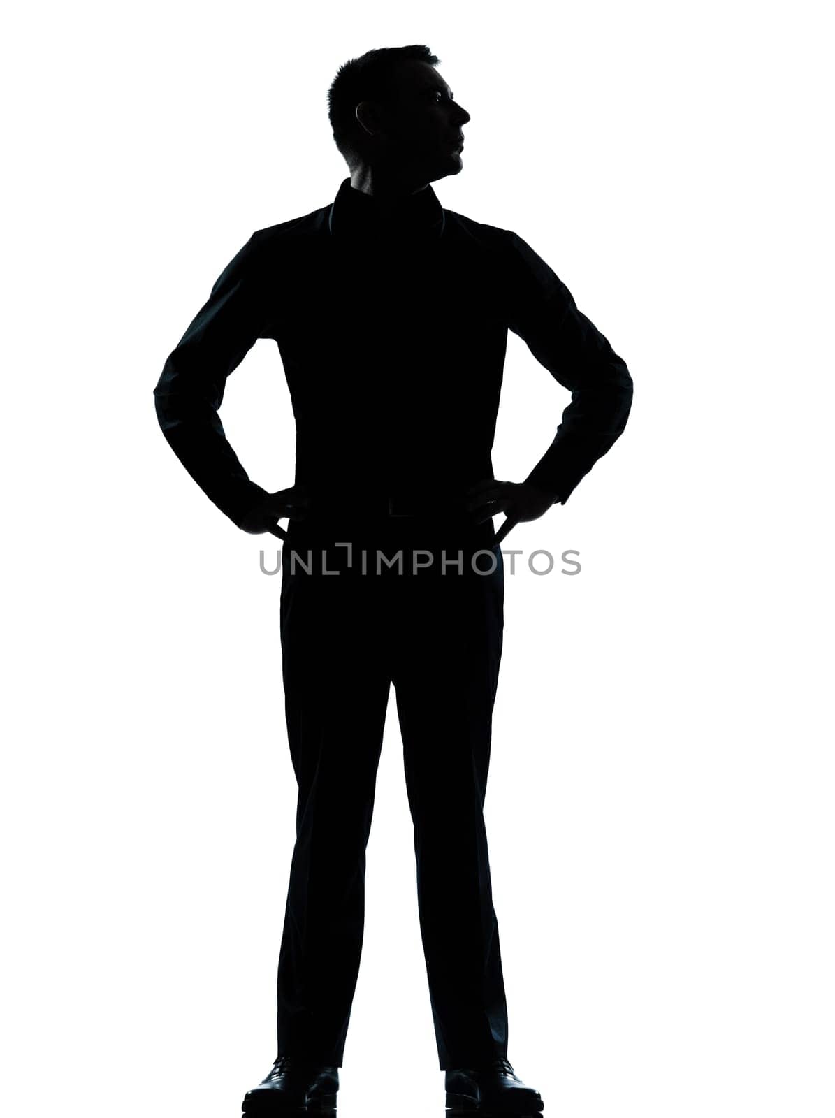 one caucasian business man silhouette standing hands on hips Full length in studio isolated on white background