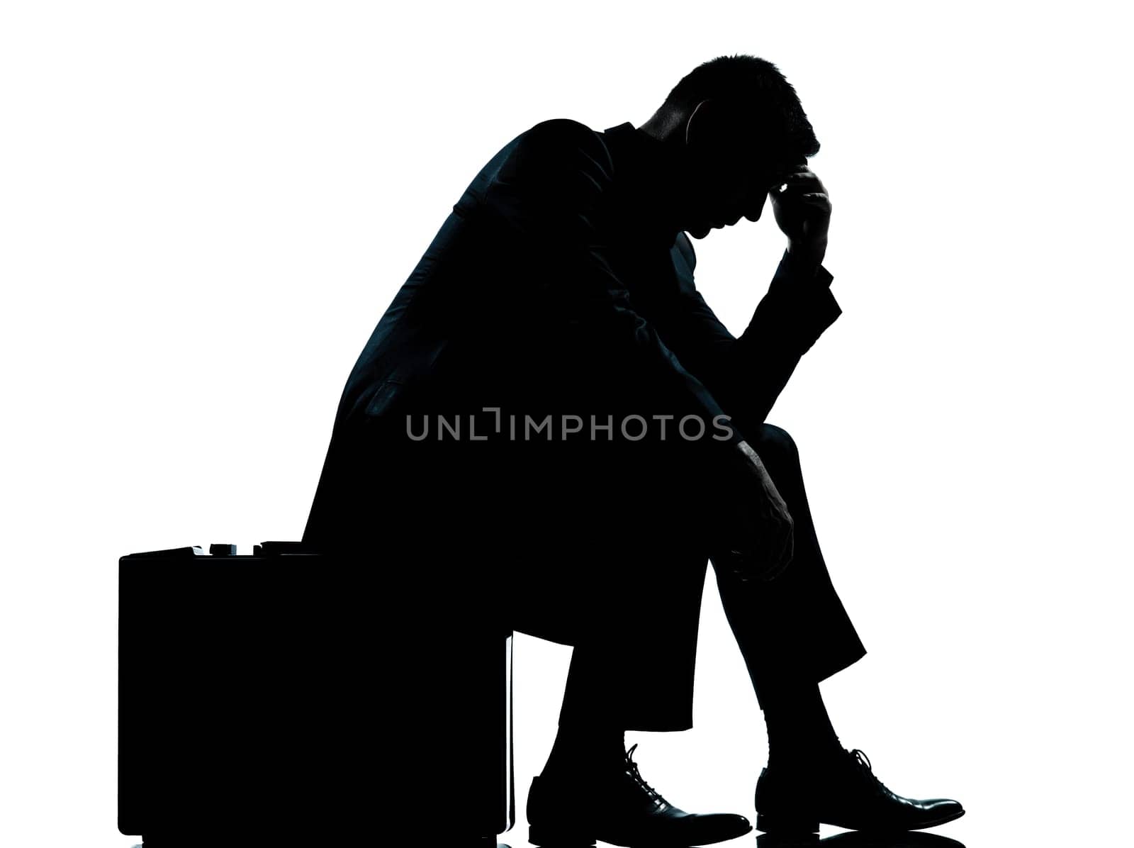 one caucasian business man sitting on suitcase tired despair silhouette Full length in studio isolated on white background