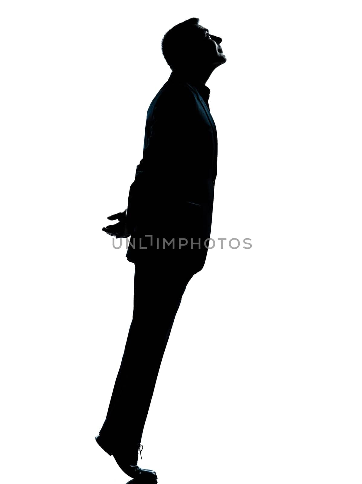 one caucasian business man silhouette standing tiptoe looking up Full length in studio isolated on white background