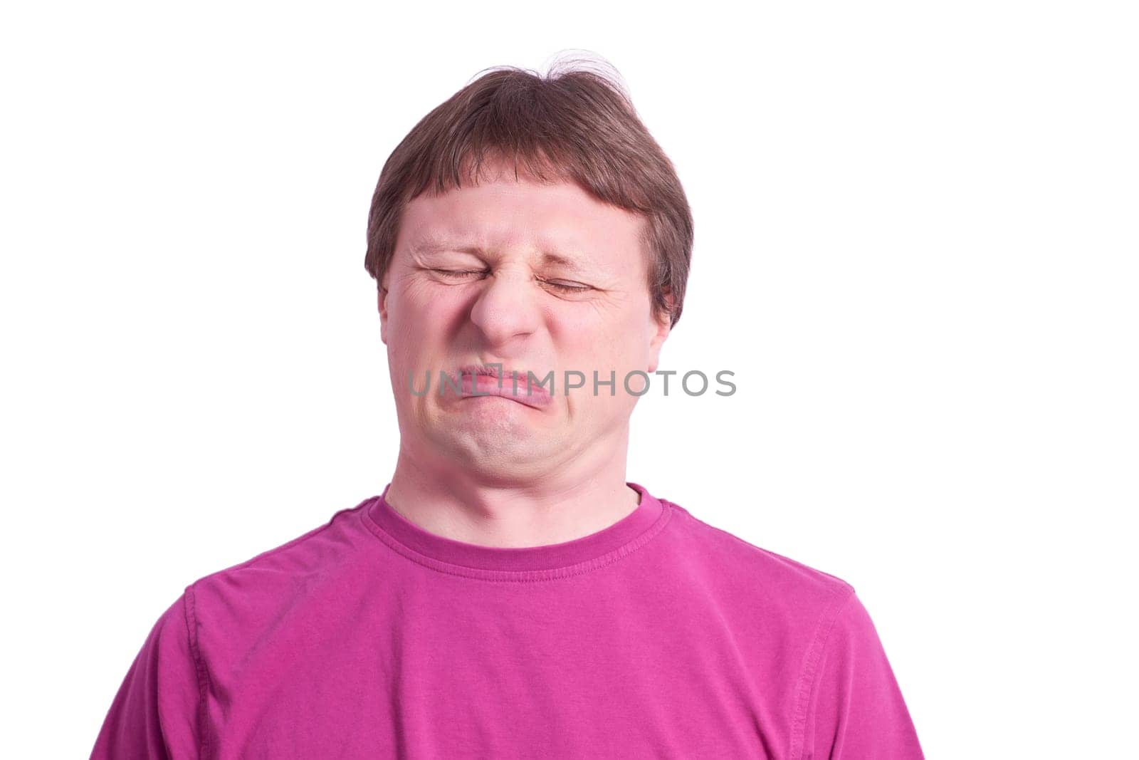 Man grimaces