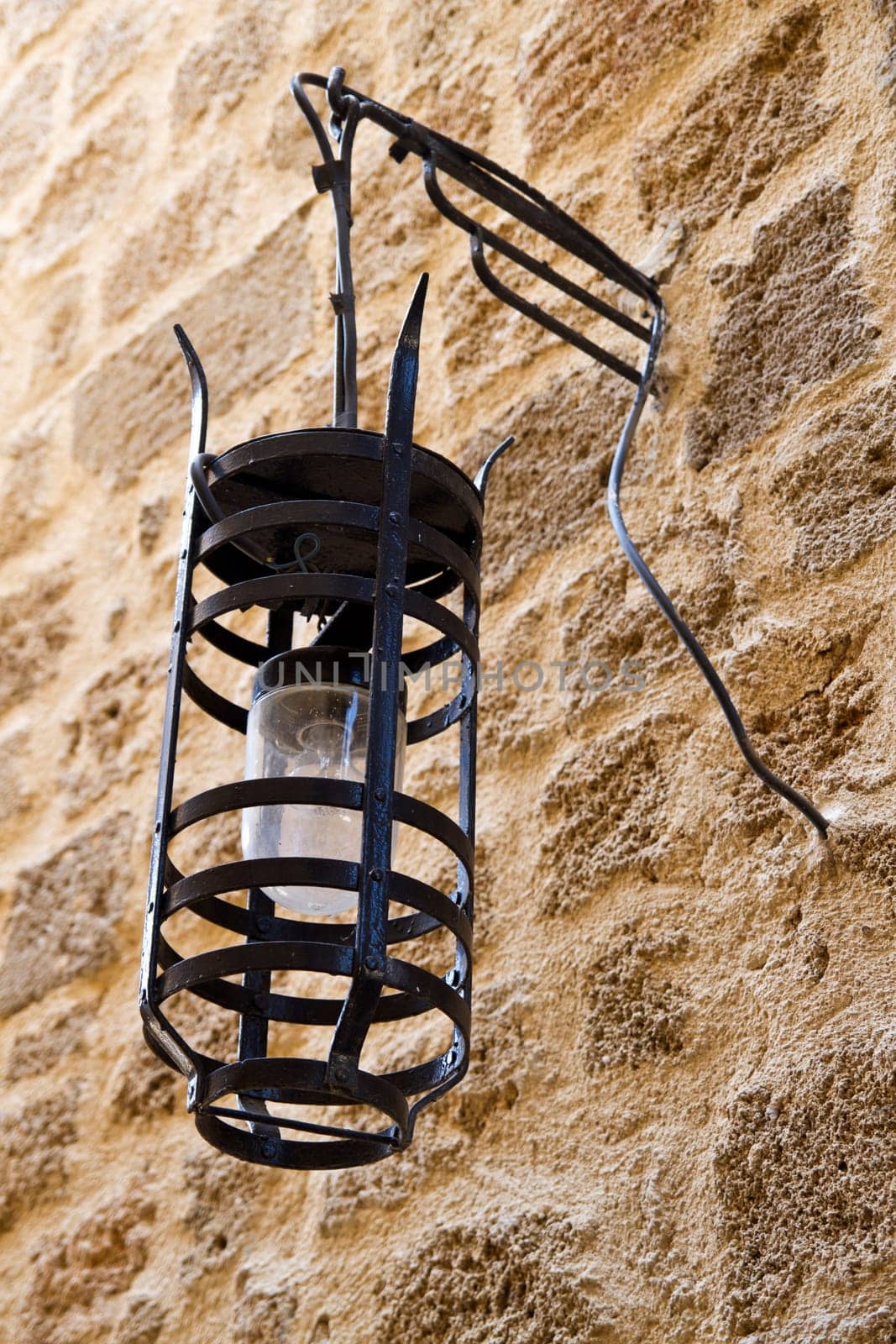 Old street light closeup on stone wall
