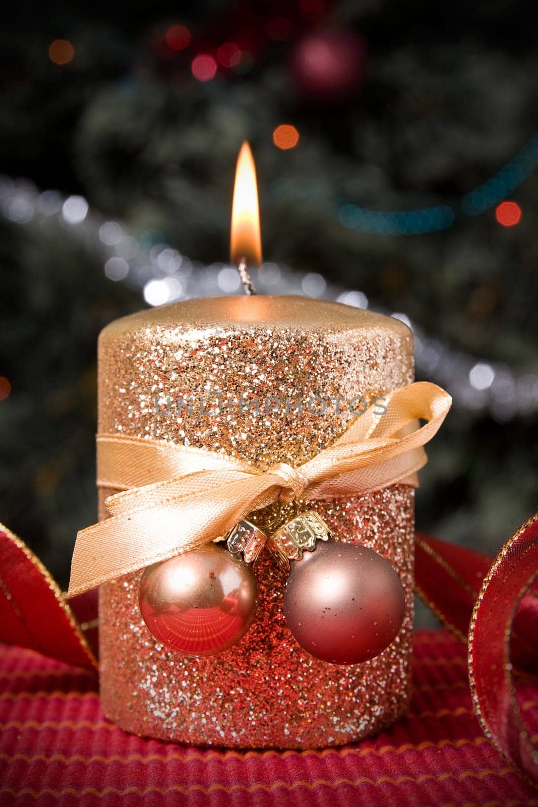 burning gold festive  candle  on xmas tree background
