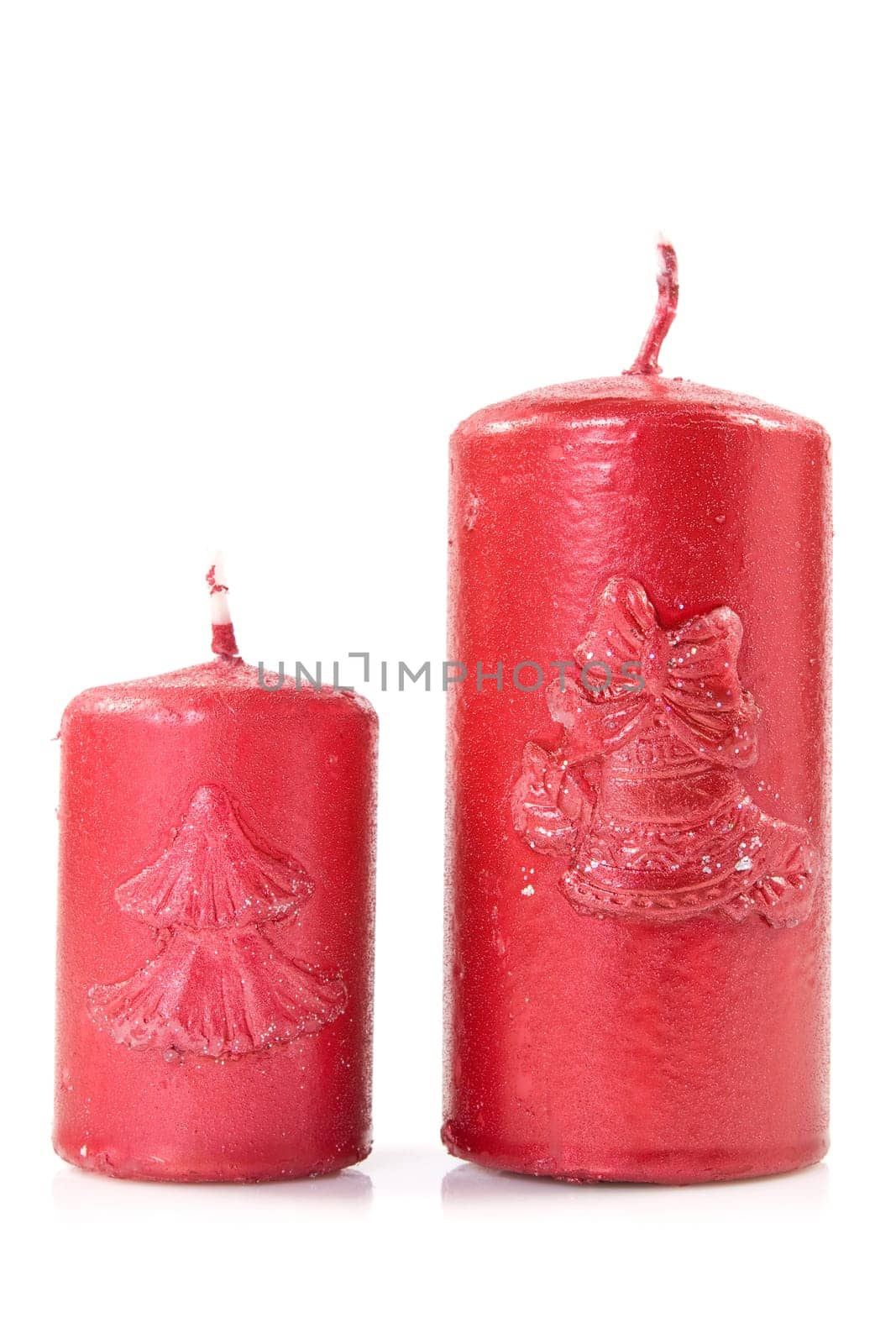 two red christmas candles on white background