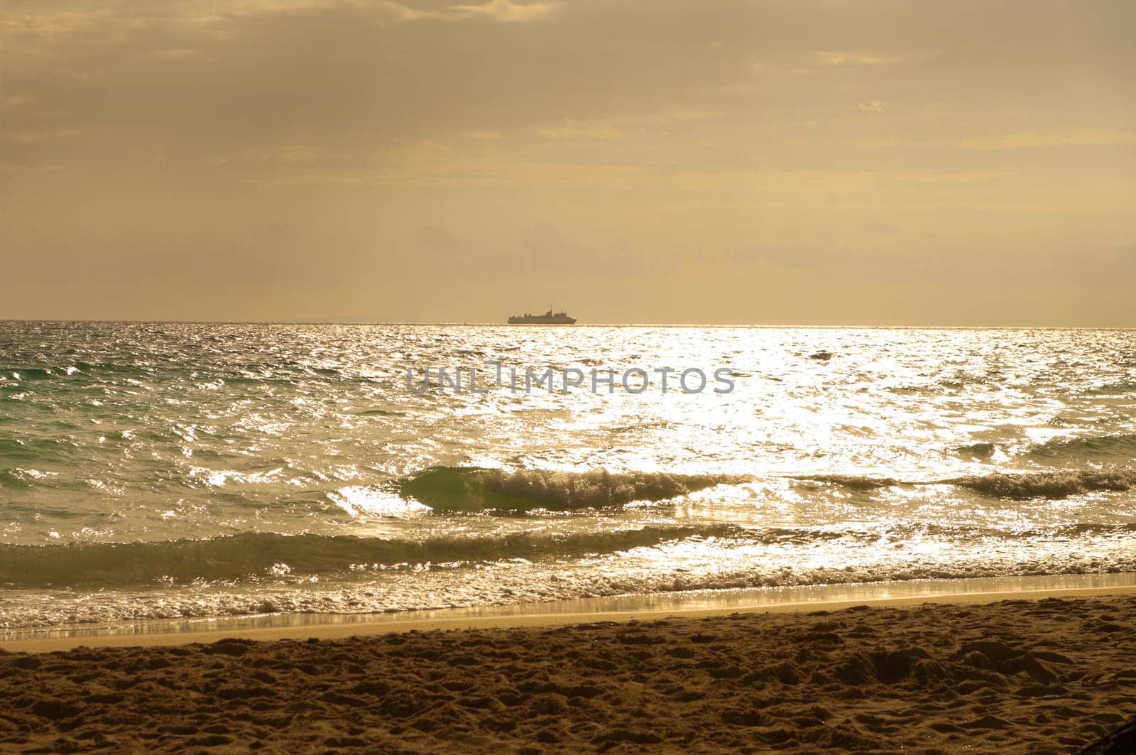 passenger ship at the horizon against a beautiful sunset