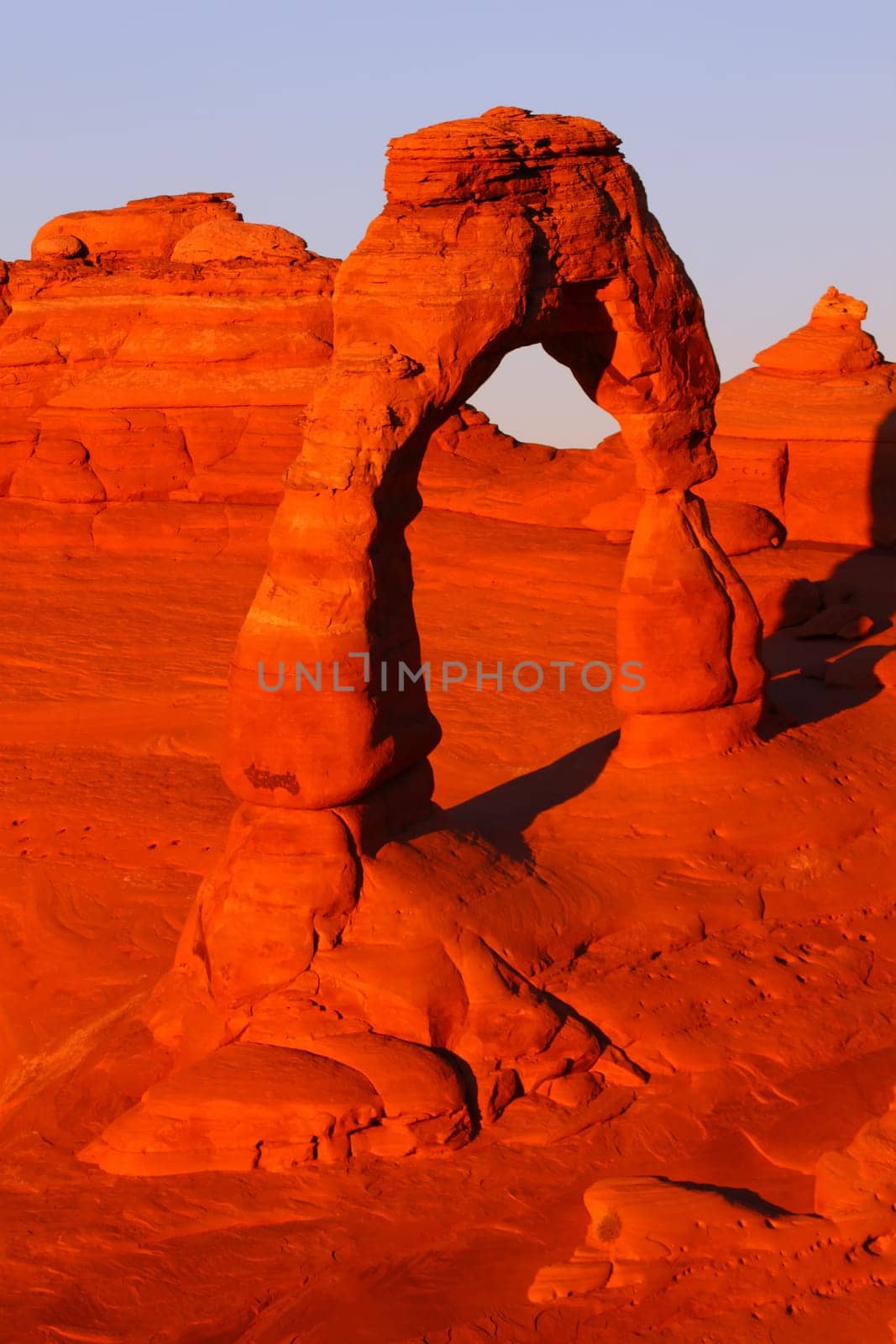 Evening sunlight illuminates Delicate Arch in Arches National Park - Utah.