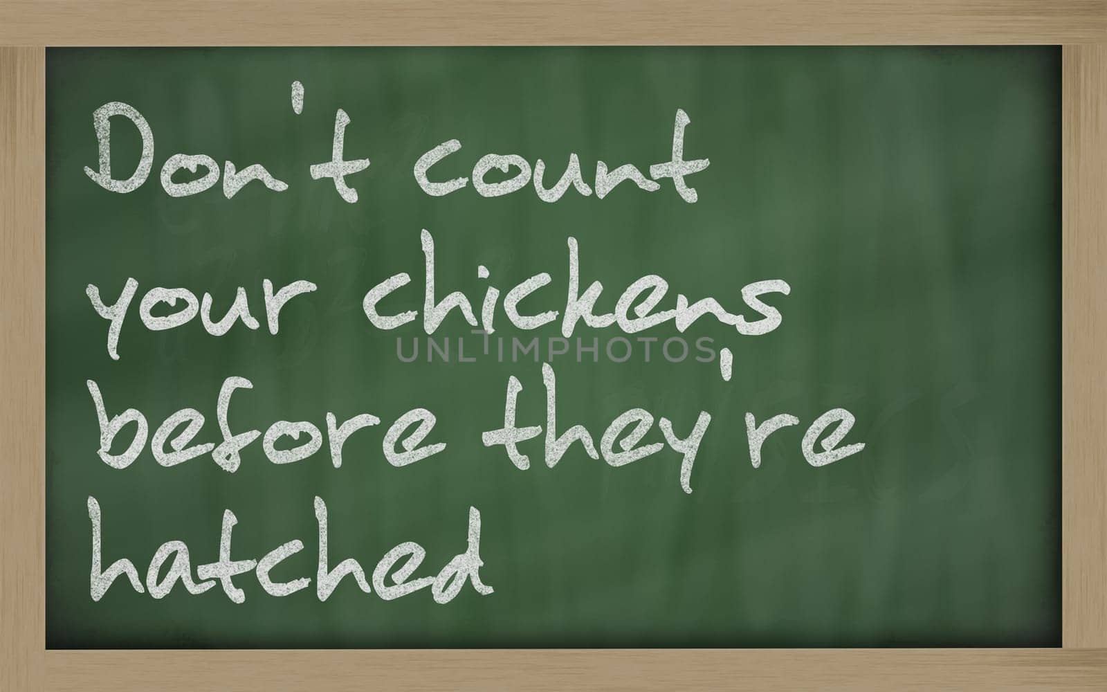 Blackboard writings " Don&#039 t count your chickens before they&#039 re hatched """
