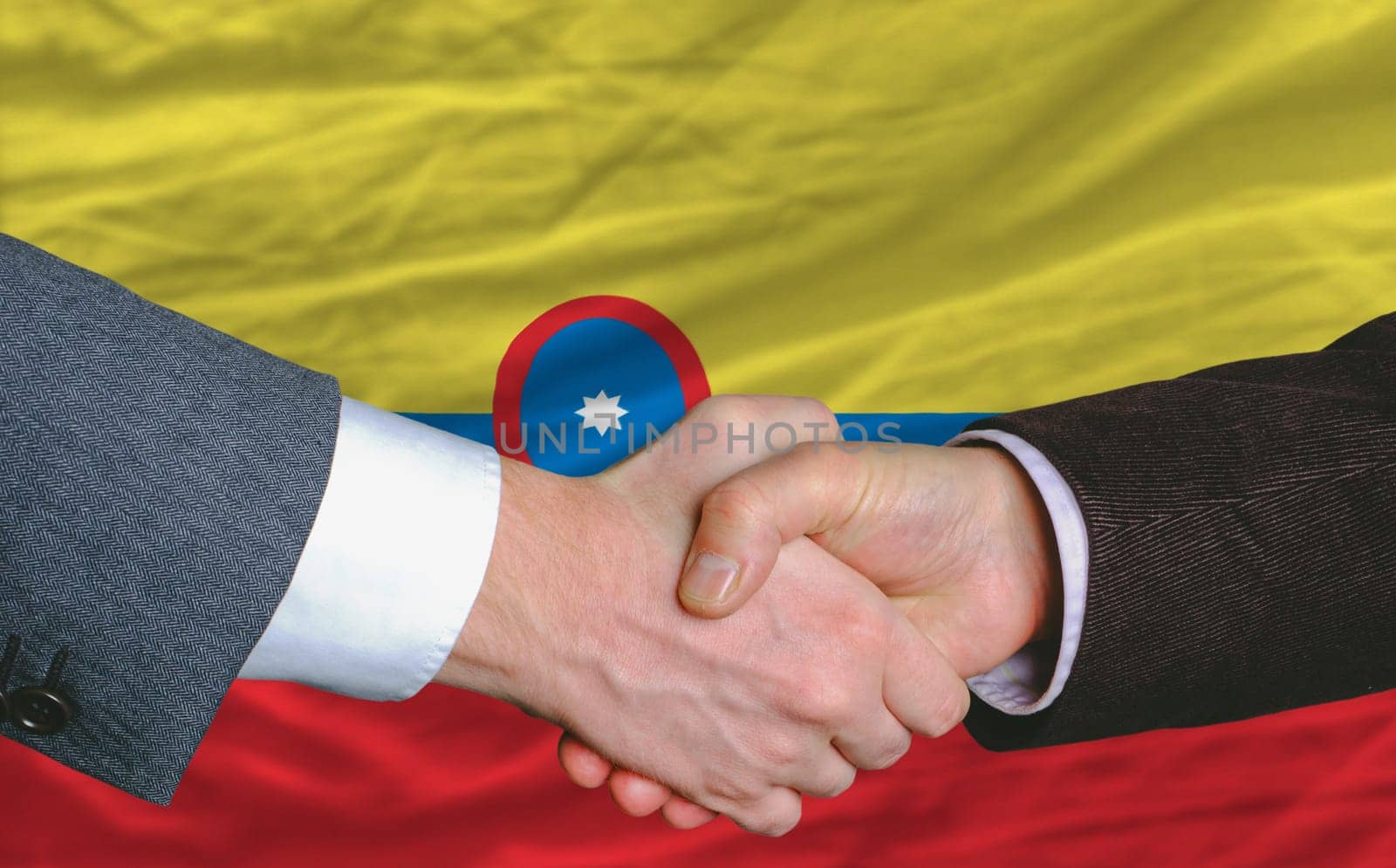 businessmen handshakeafter good deal in front of columbia flag