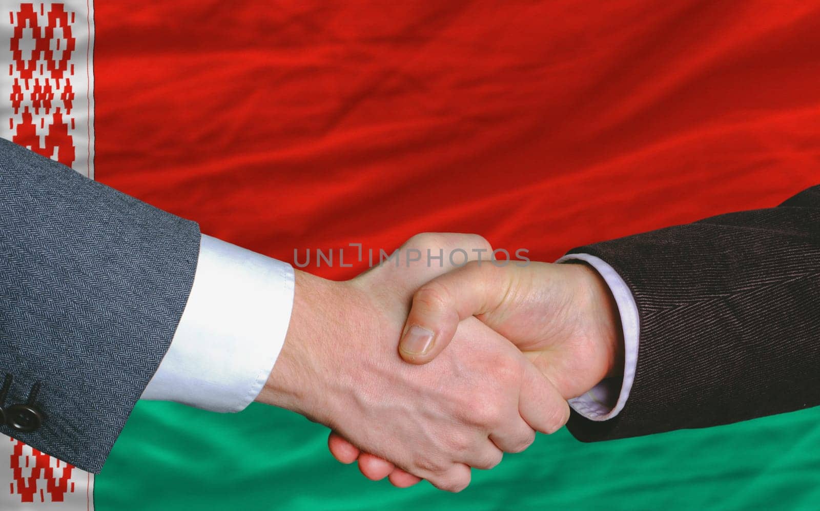 businessmen handshakeafter good deal in front of belarus flag