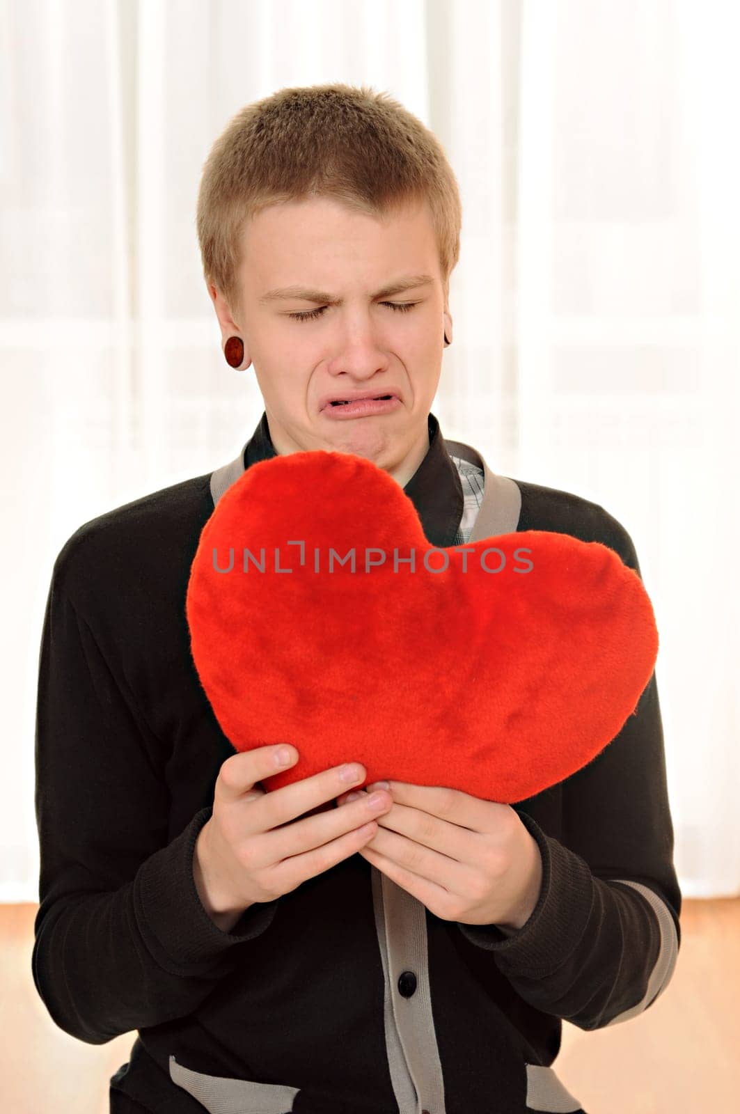 frustrated teenager  with a teddy heart in hand