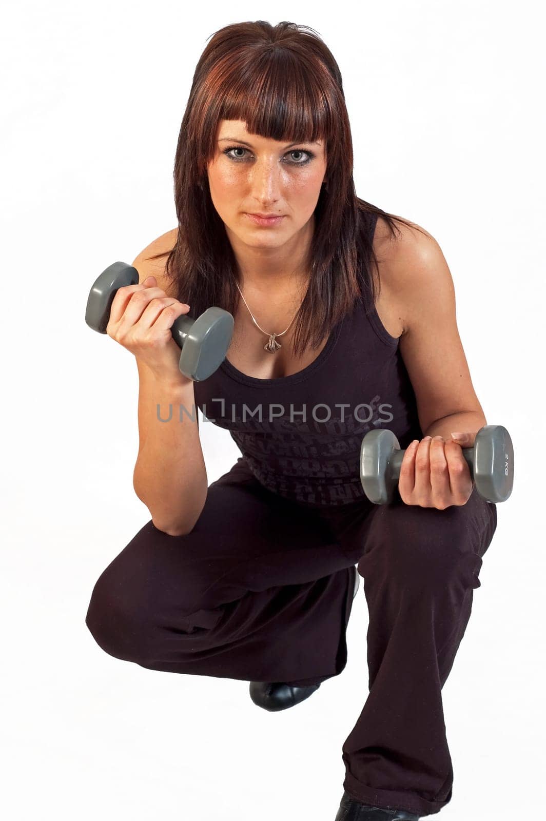 young woman lifting weights on white background