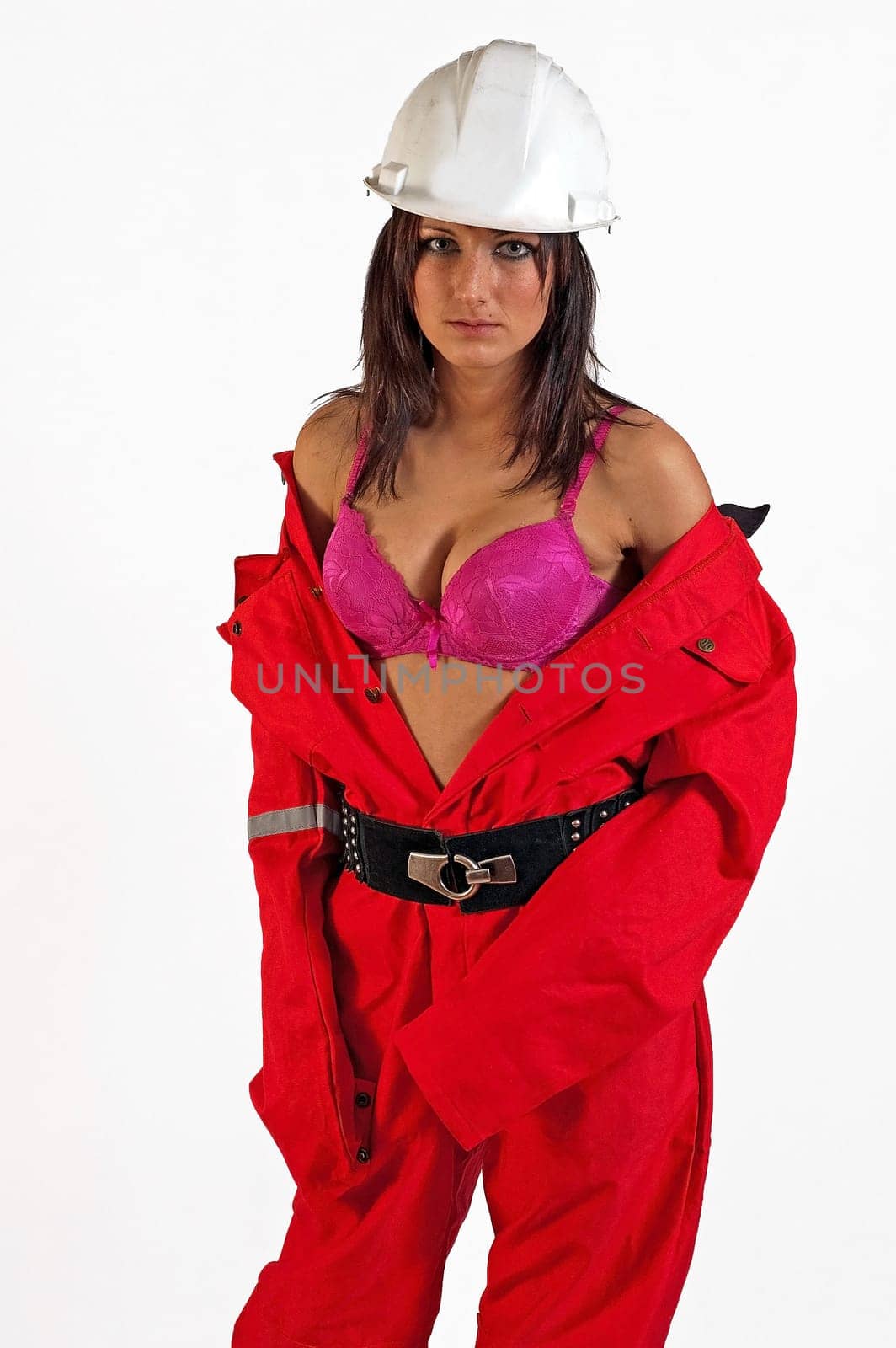 young sexy woman builder in white helmet holding driller