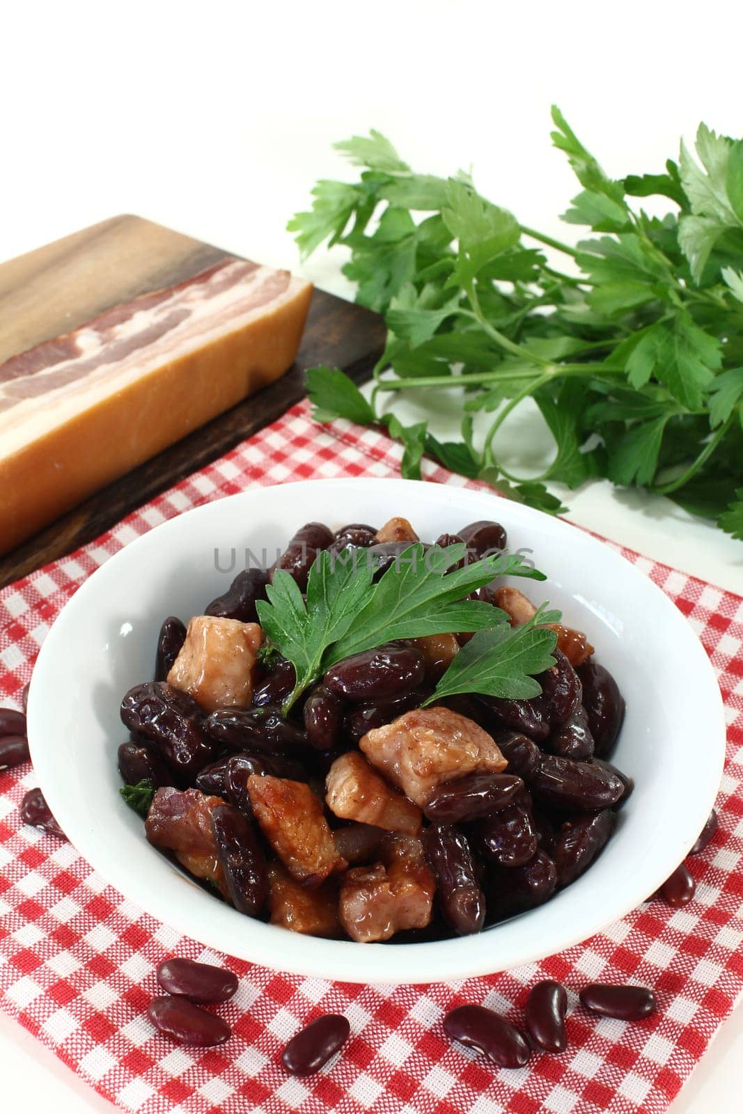 a bowl of kidney beans,parsley and fried bacon