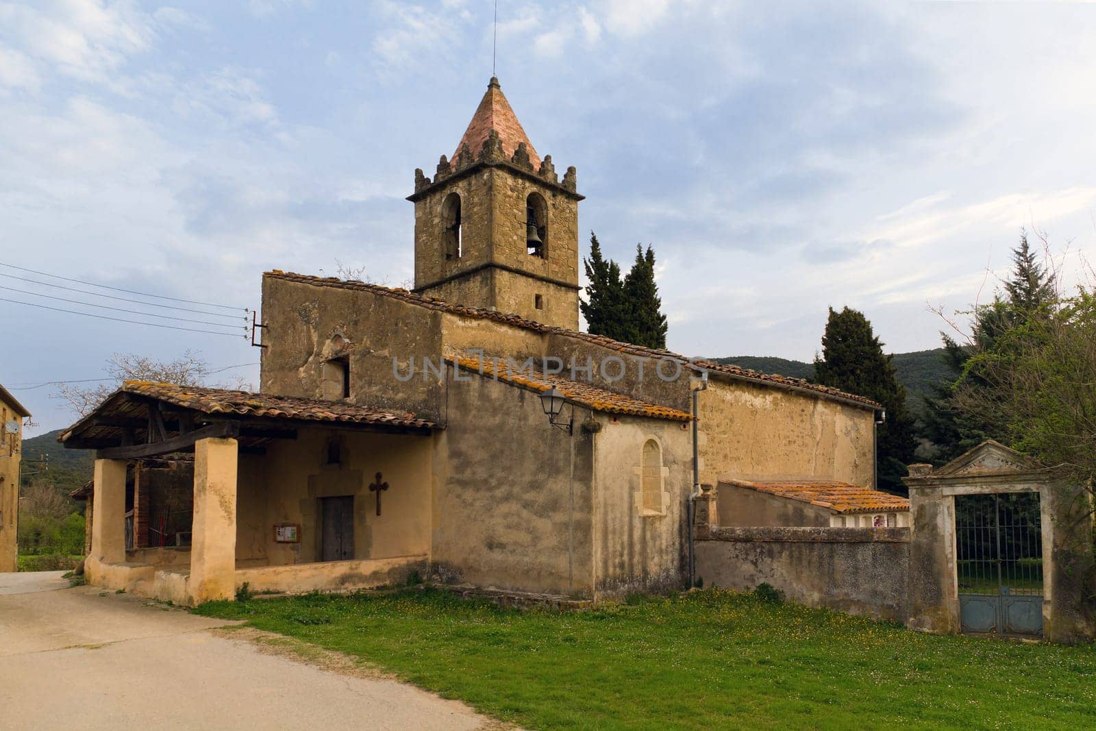 Cogolls, Barcelona. Typical Catalan countryside, rural grass, the church, surrounded by mountains.