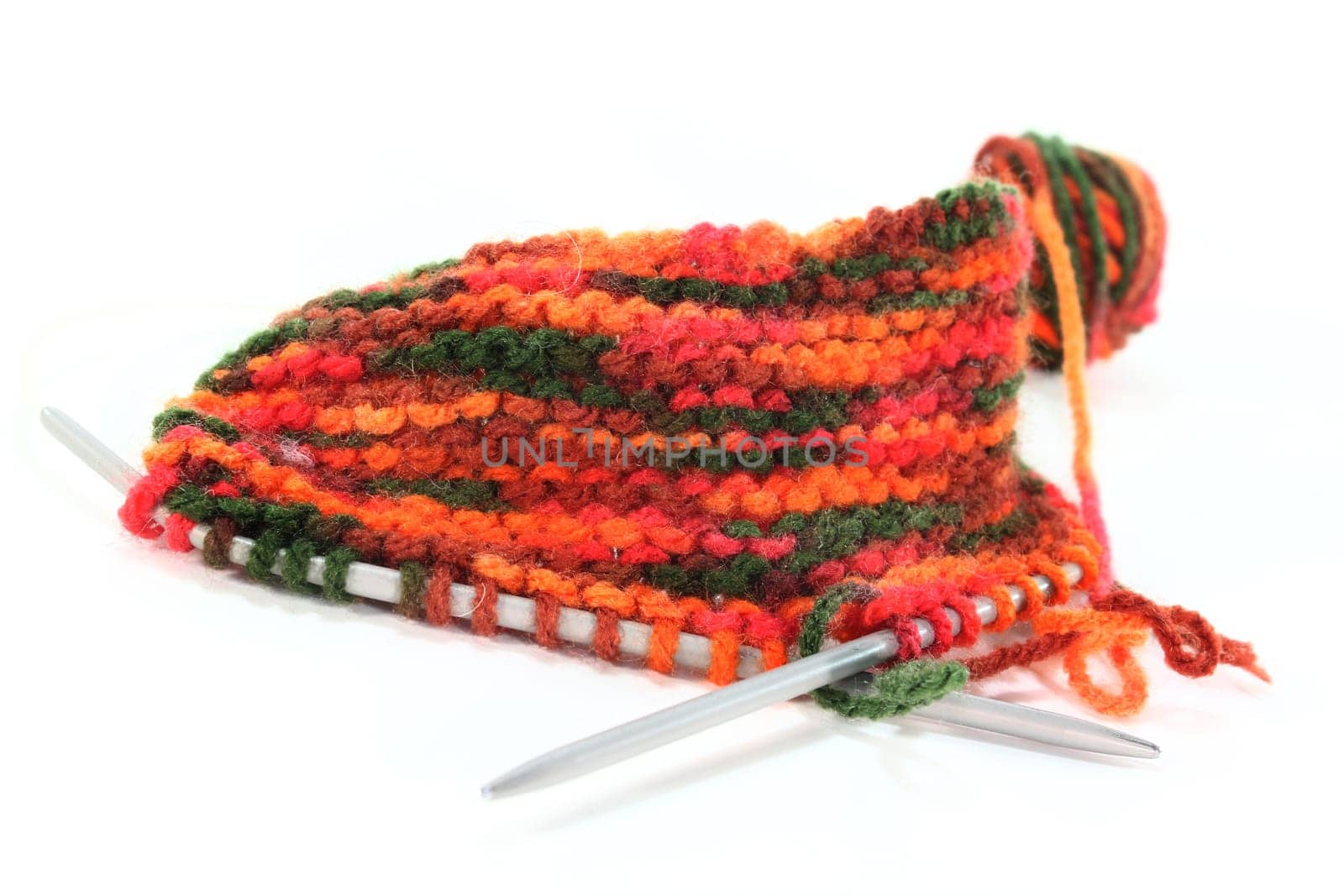 a colourful ball of wool with a knitting sample