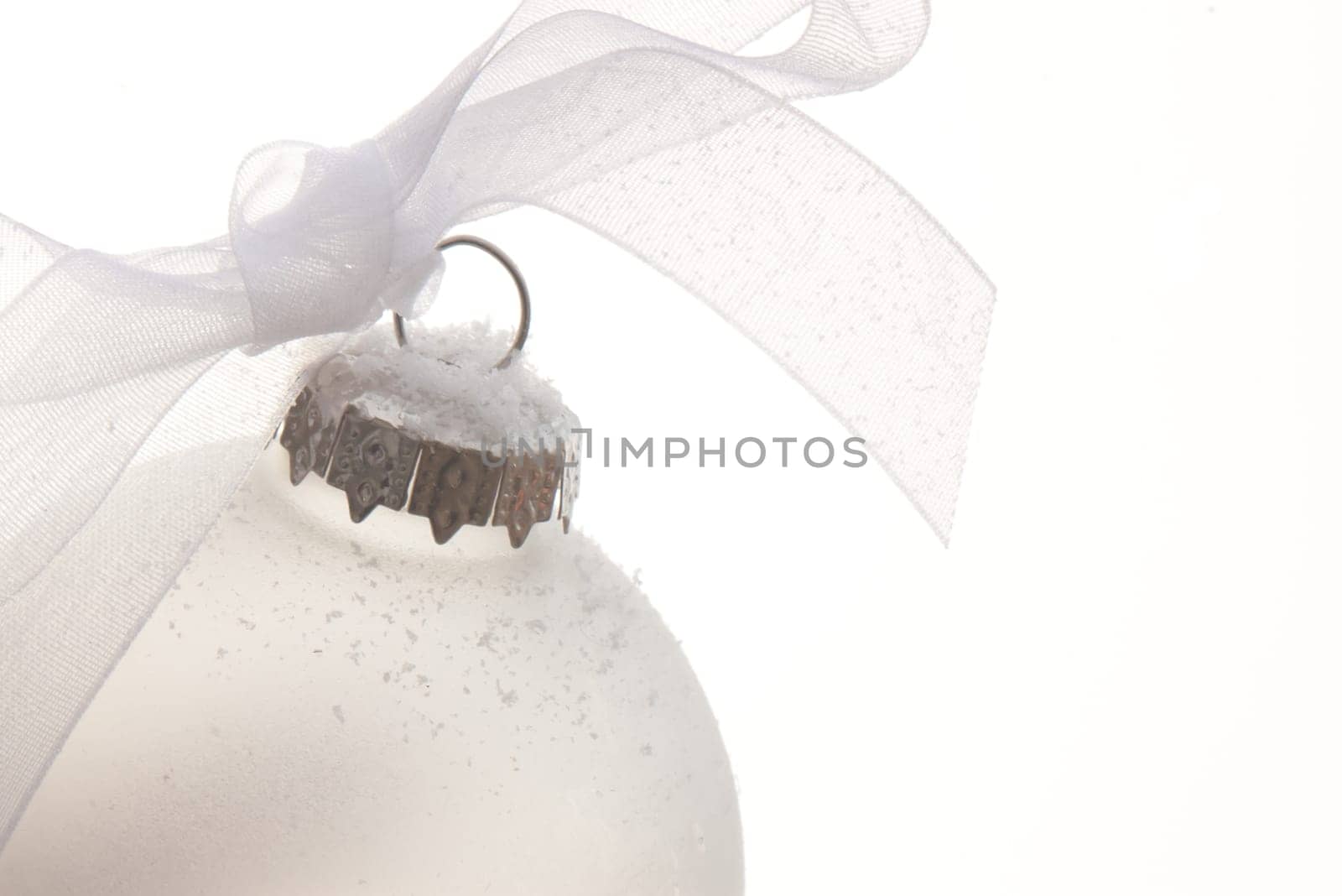 white christmas ornament hanging on a christmas tree