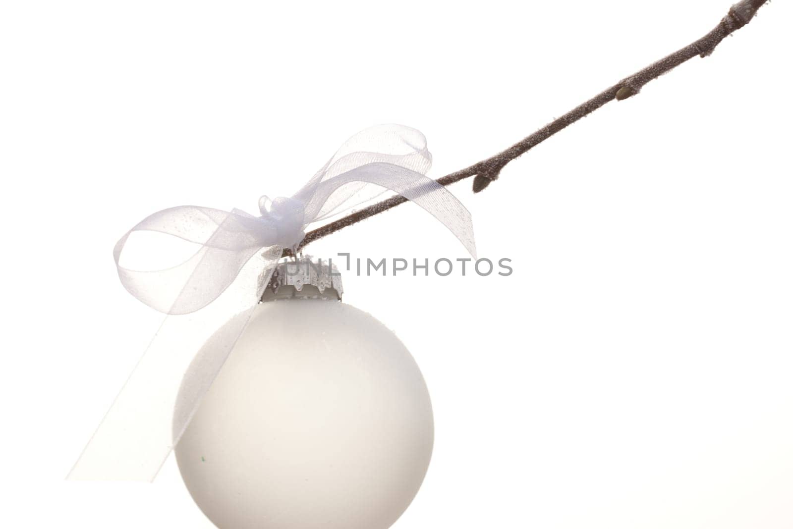 white christmas ornament hanging on a christmas tree