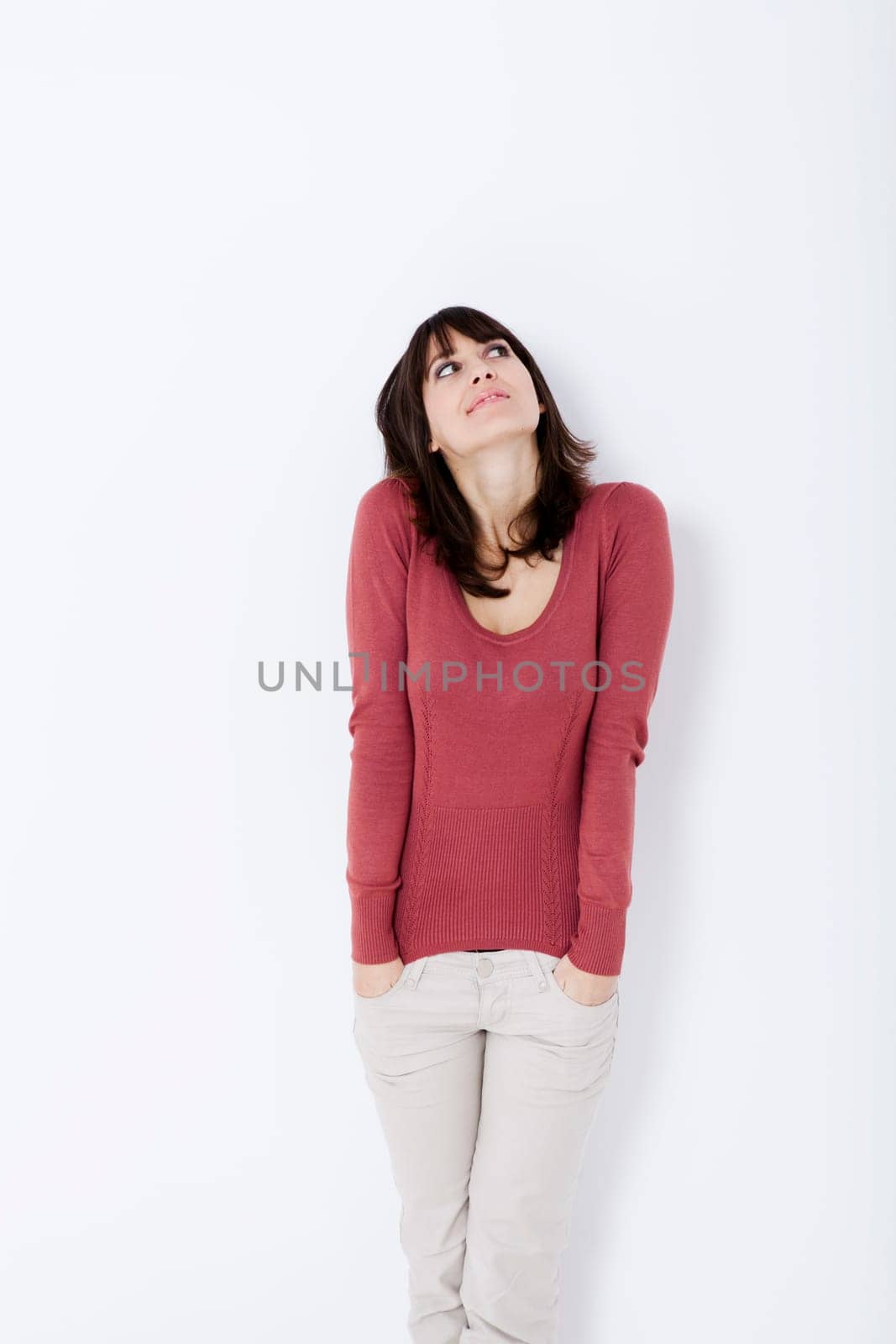Beautiful woman standing and looking up. Studio shot.