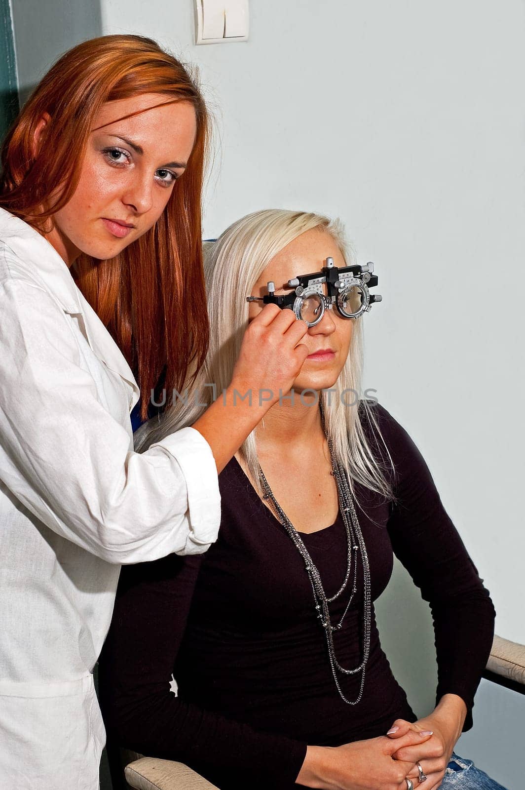 Young woman examining the eyesight in the optician&#039 s