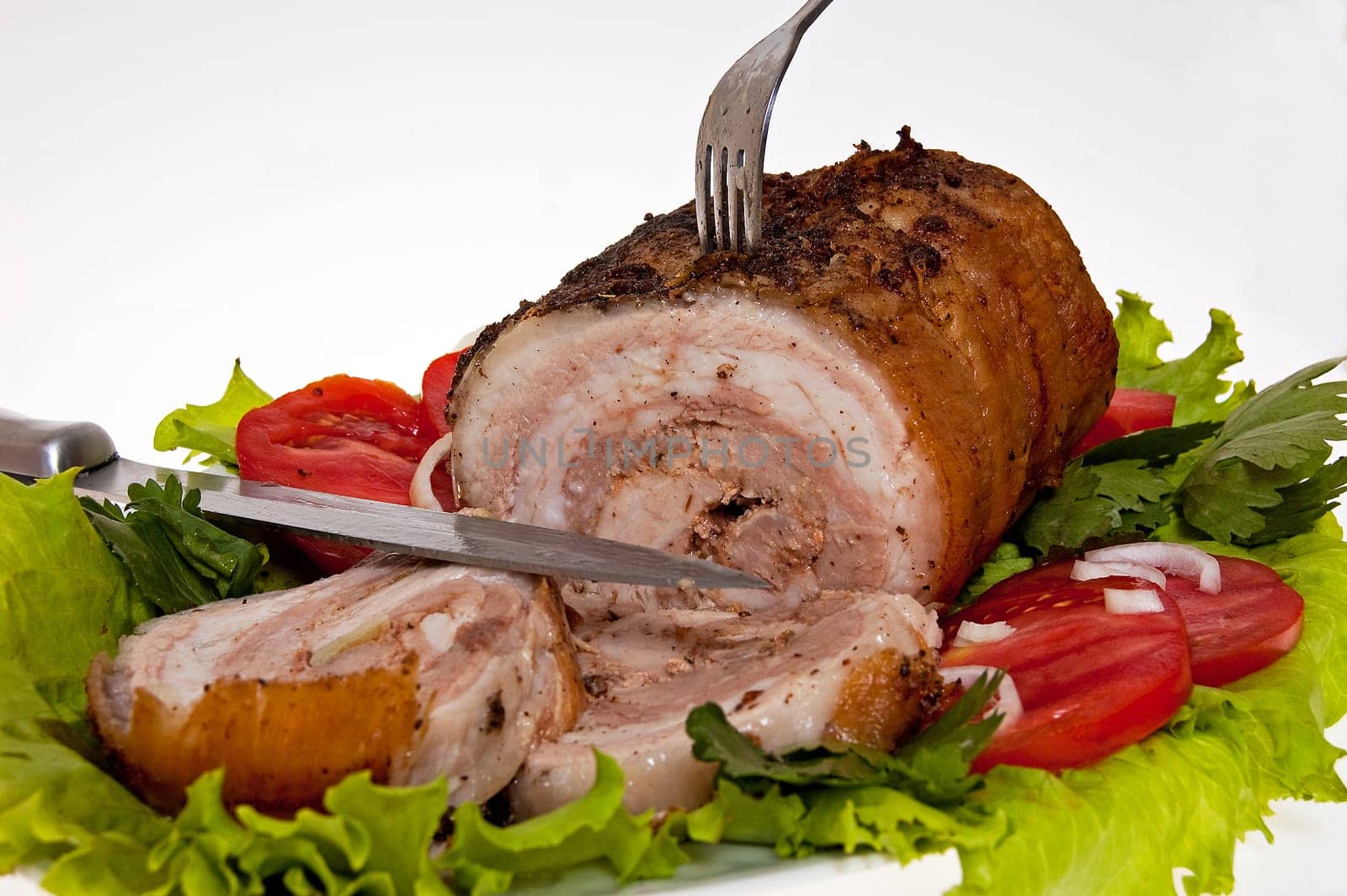 roast pork in tomatoes on the white background