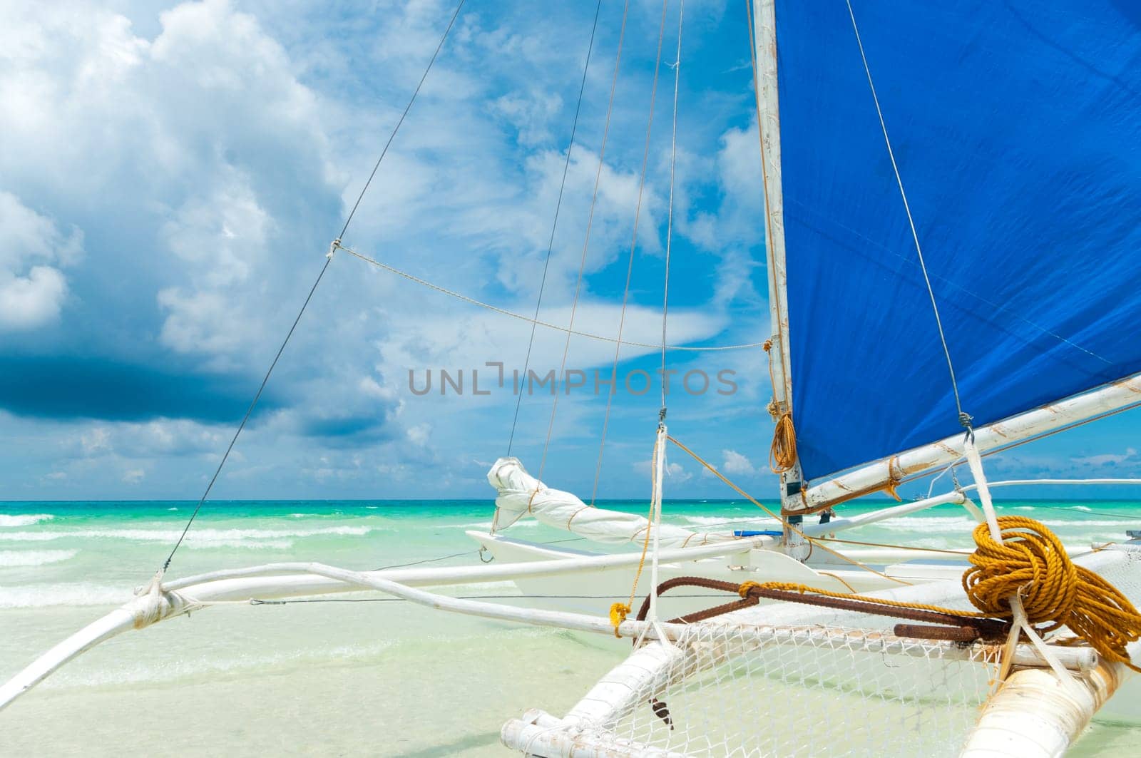 detail of a traditional paraw sailing boats on white beach on boracay island, Philippines