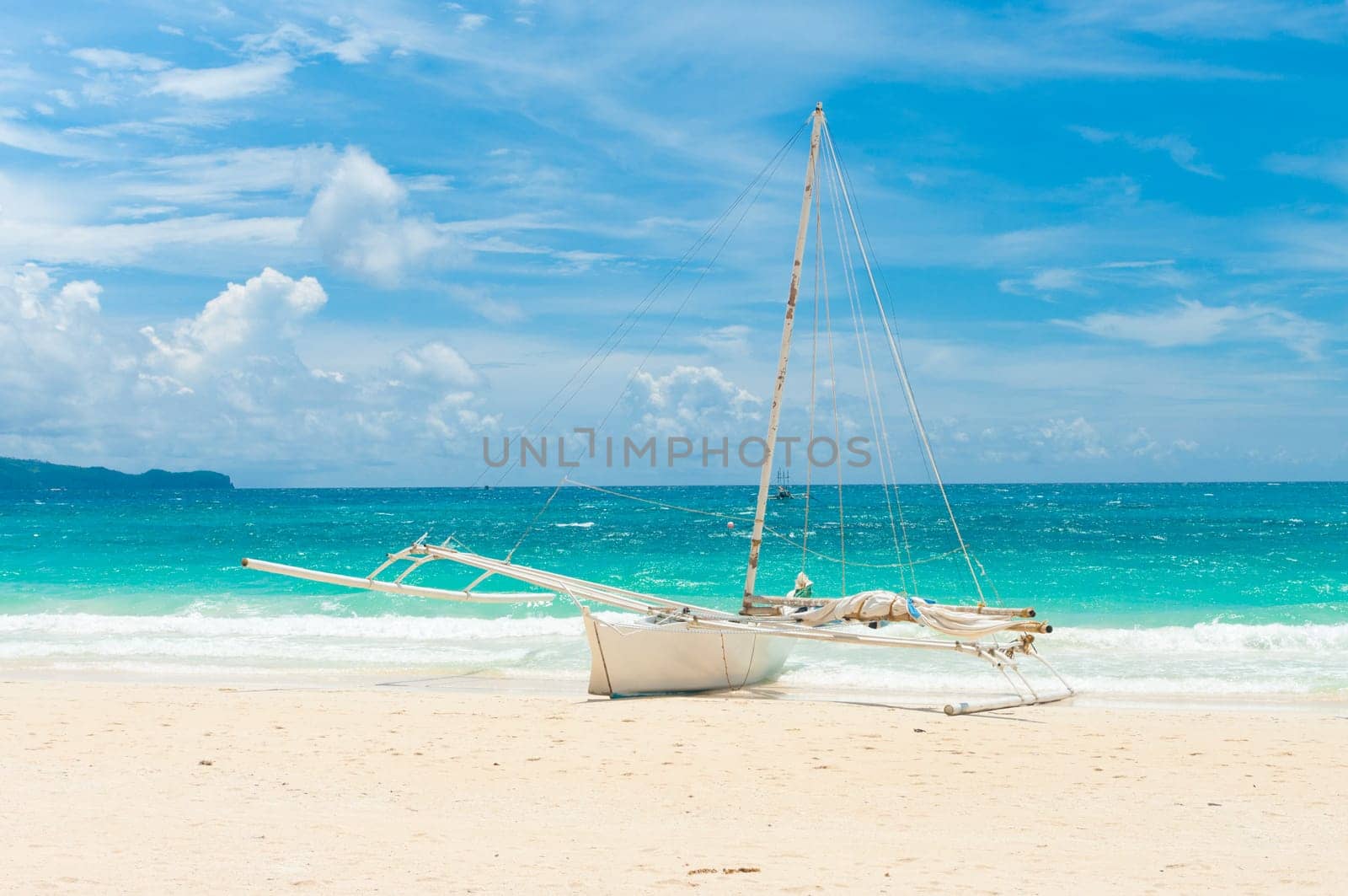 traditional paraw sailing boat on white beach on boracay island, Philippines