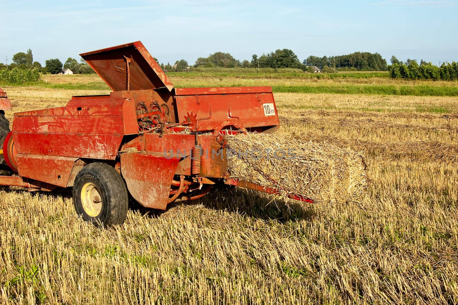 A combine harvester doing his work on a wheat field.