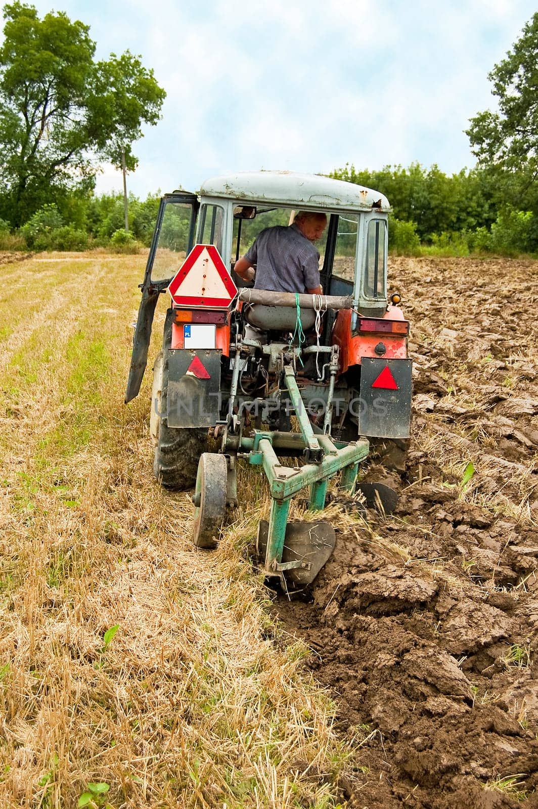 ploughing field on old tractor in southern Poland
