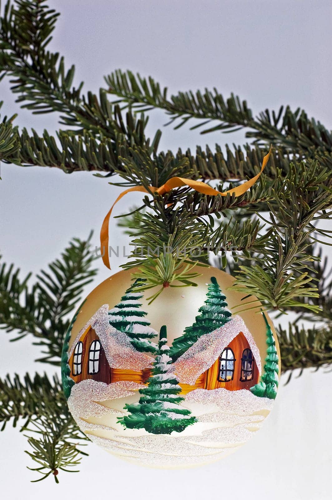 Detail of christmas tree with white glass ball.