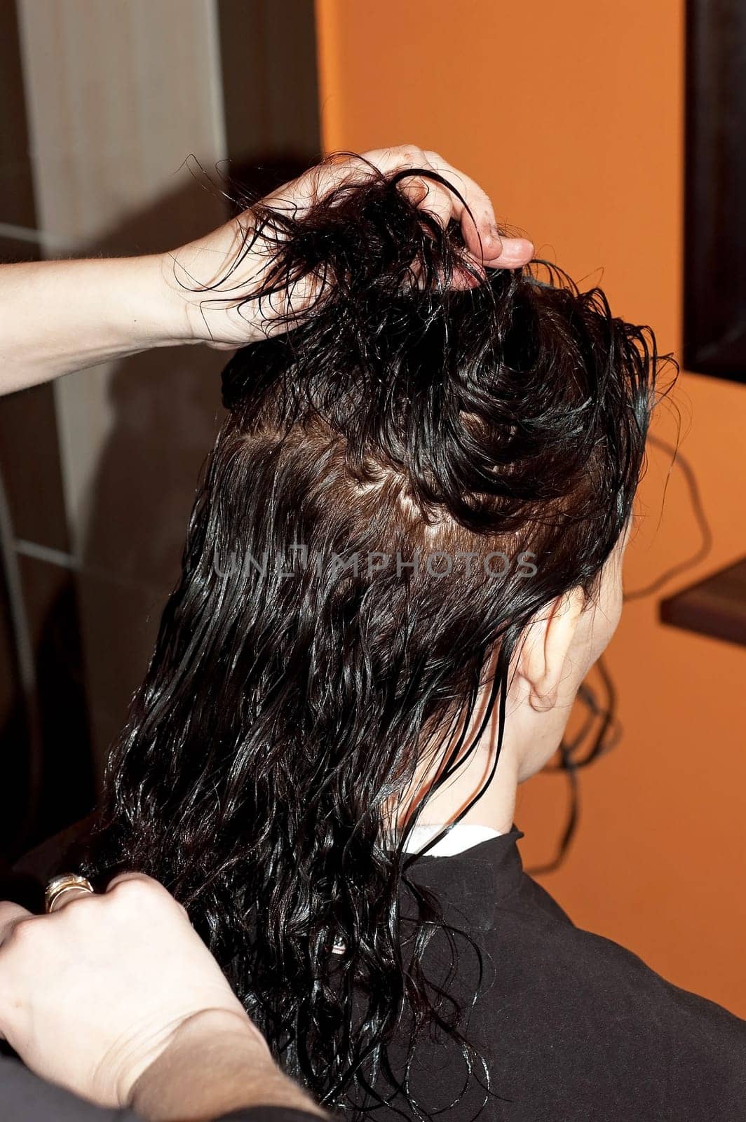 Stylist work on woman hair in salon