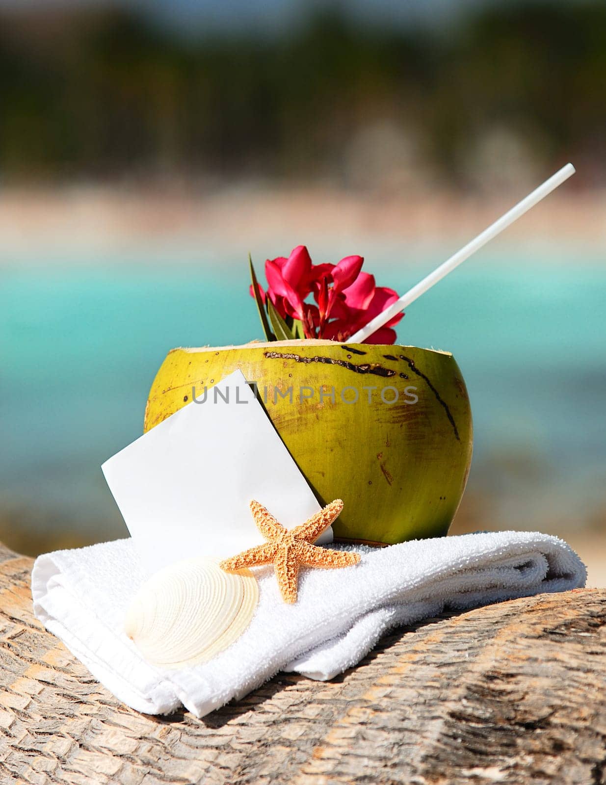 Coconut cocktail starfish tropical Caribbean beach refreshment and towel