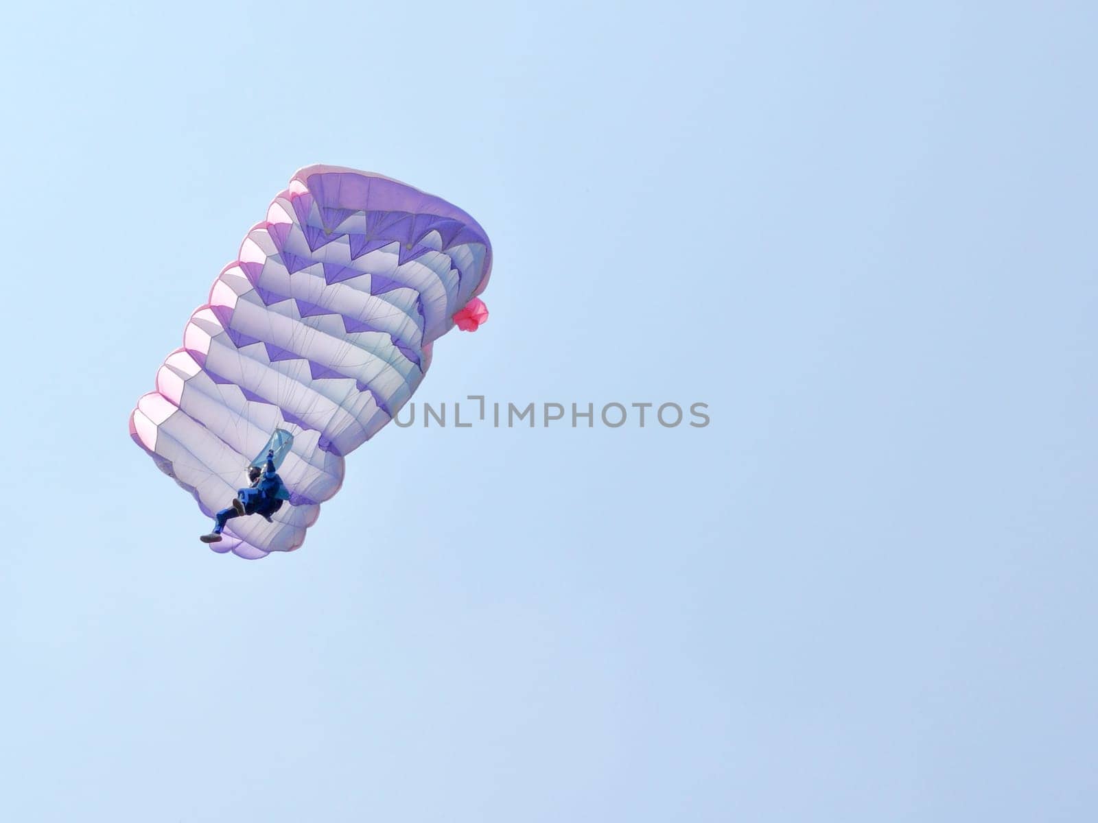 A parachute over a blue sky background