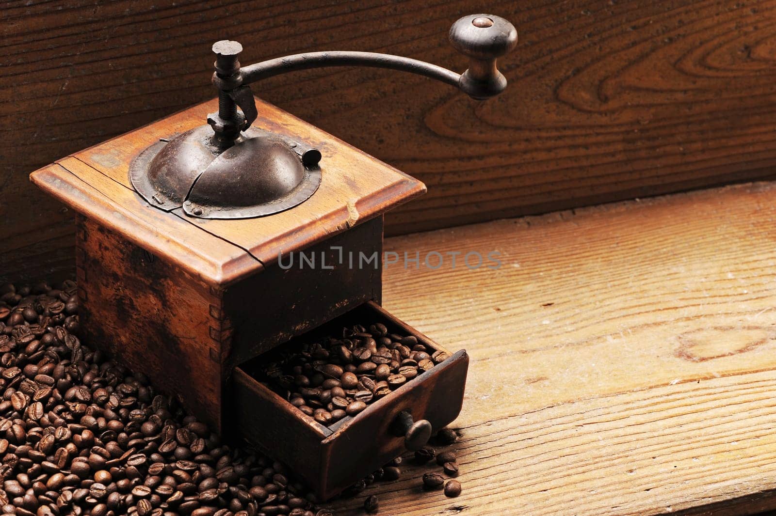 Roasted coffee beans are ground in a coffee grinder.