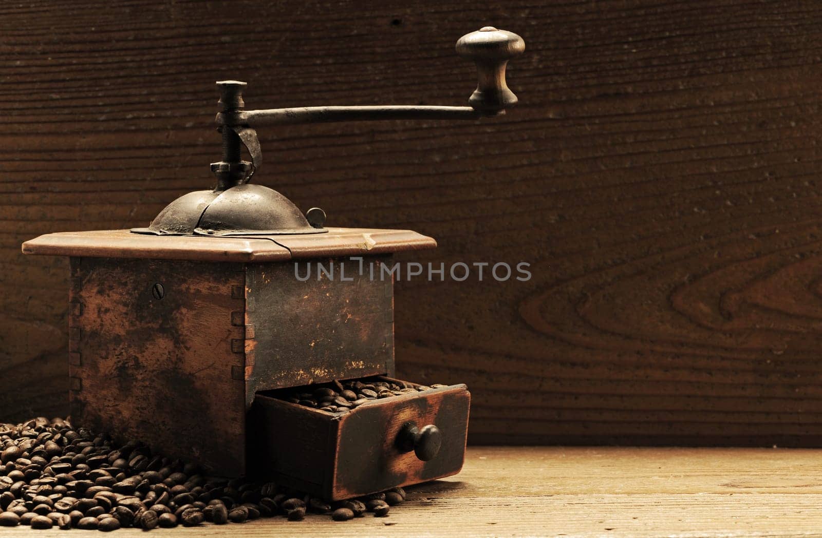 Roasted coffee beans are ground in a coffee grinder.