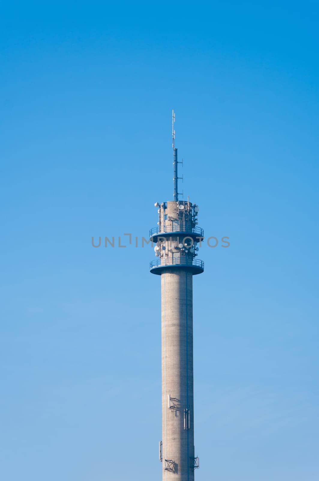 large tower full with antennas and satellite dishes
