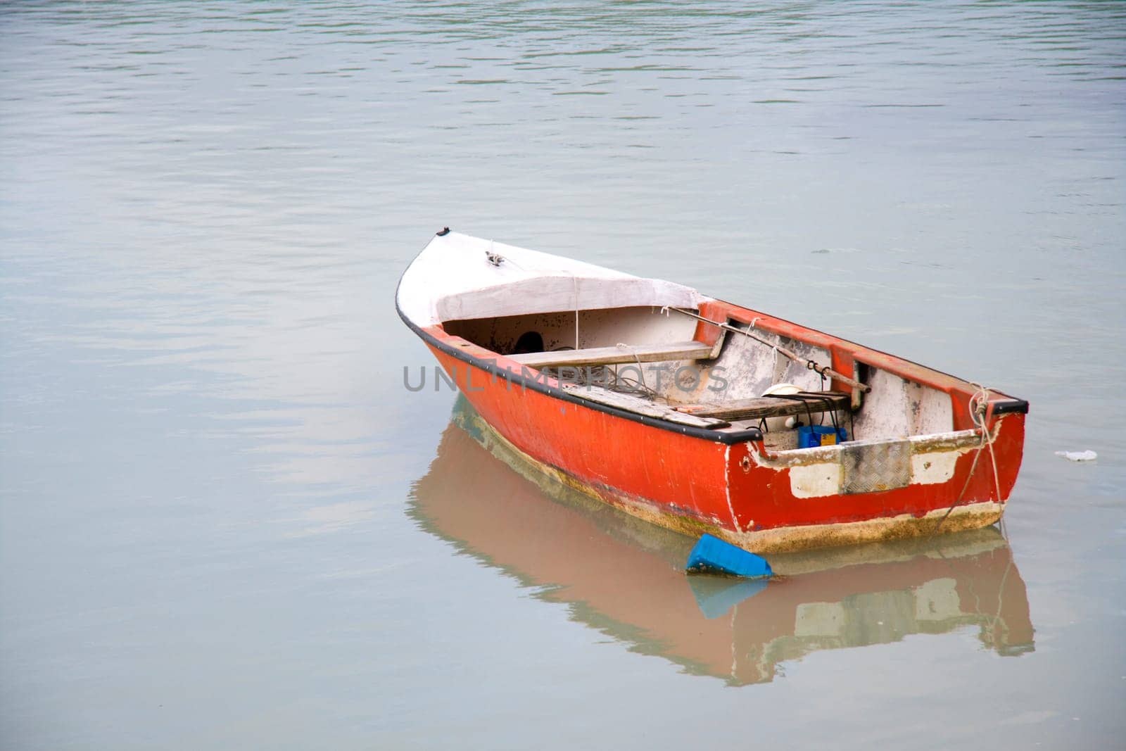 Small old boat is anchored in the bay