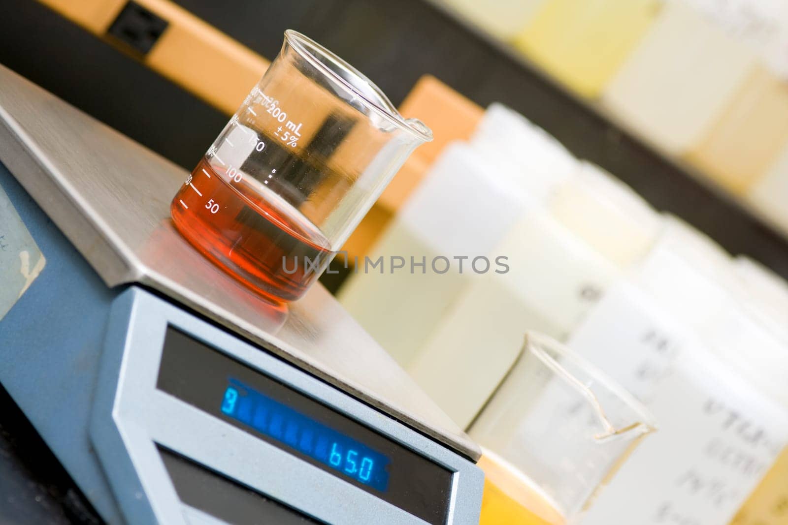 Chemical laboratory equipment - beaker with oil on the scale.