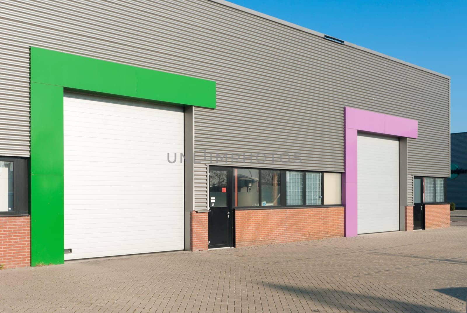 industrial warehouse with roller doors with different color accents