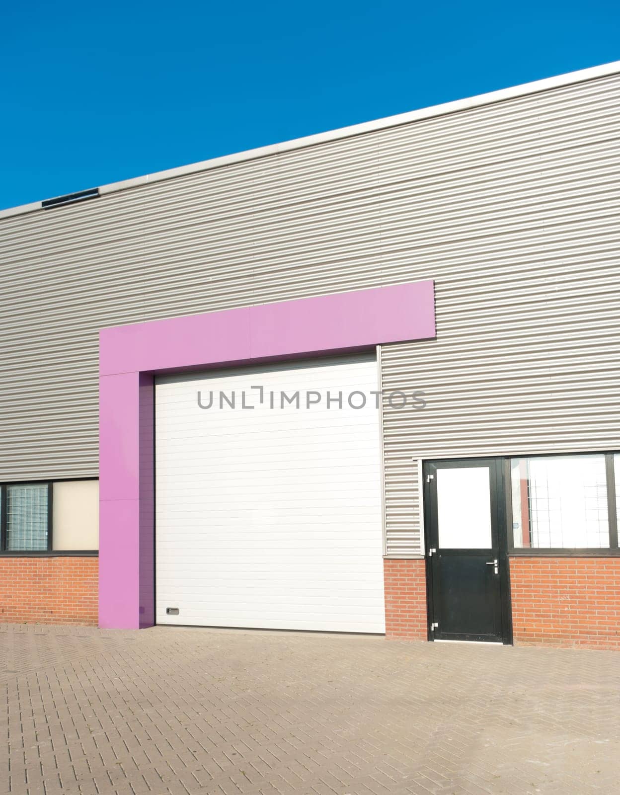 industrial warehouse with roller door with pink accent