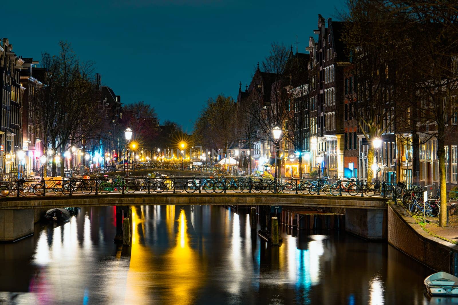Captivating Night in Amsterdam: A Mesmerizing Long Exposure Photo of Amsterdam's Nighttime Canals by PhotoTime