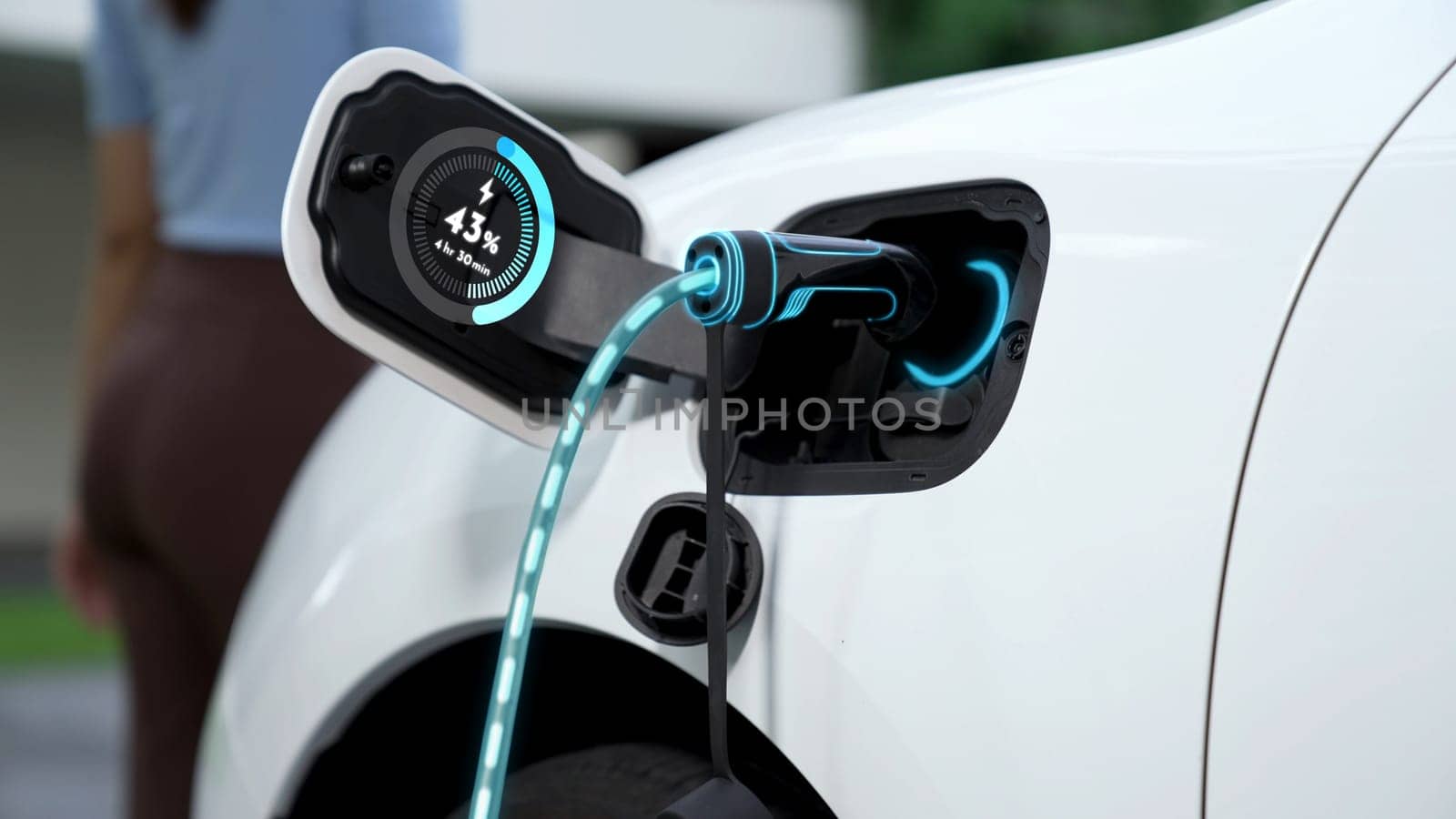 EV charger from home charging station plug in and recharging EV car display battery status hologram with blurred background of modern woman walking. Smart futuristic home energy infrastructure. Peruse