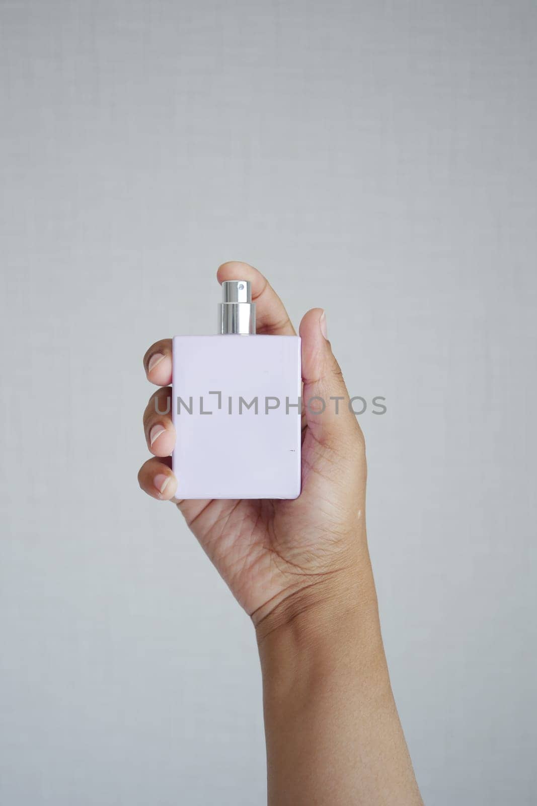 women hand holding a perfume by towfiq007